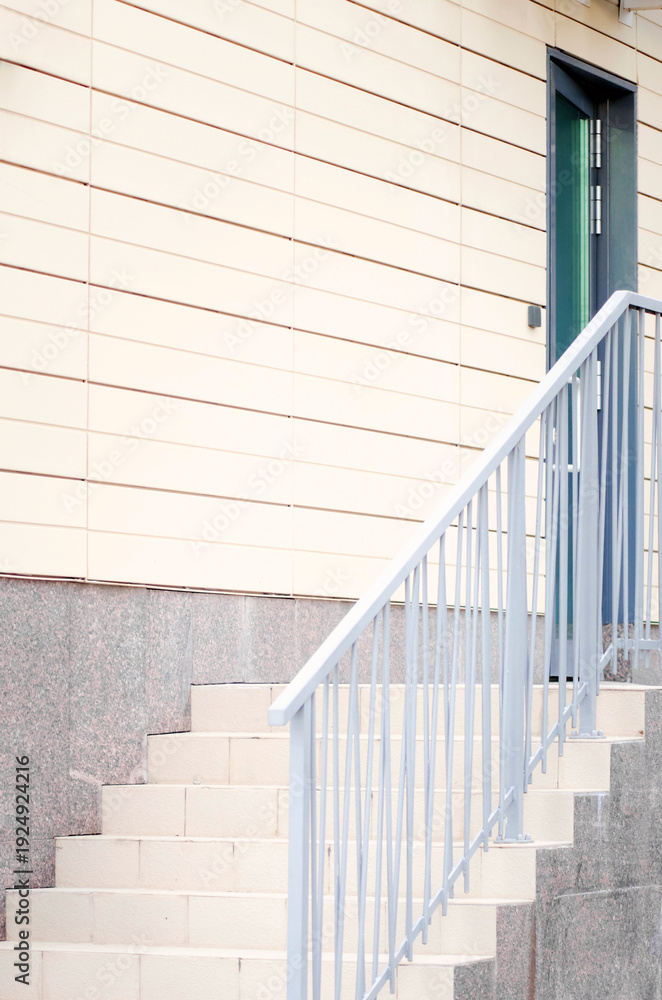 Fototapeta premium Stairs at the entrance to the house. Vertical photograph.