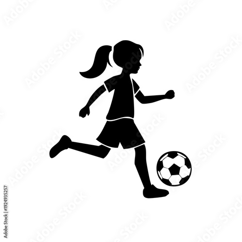Young girl kicking soccer ball with determination and energy in a dynamic outdoor scene