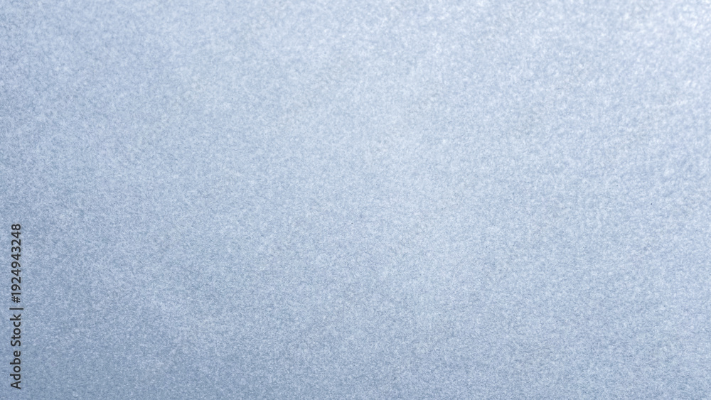 Fototapeta premium Glistening light blue grainy surface background with small shimmering shiny glitter particles