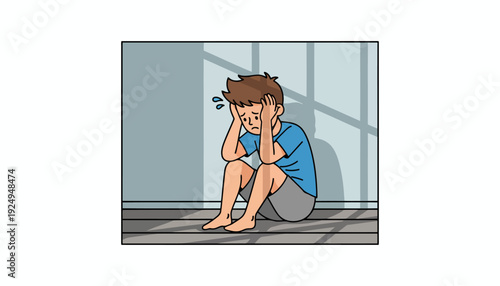 Sad boy sitting on floor with hands covering his face.