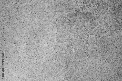 Detailed close up of rough grey granular stone surface providing an abstract textured background