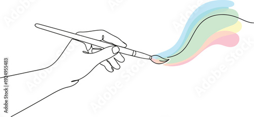 Hand holding paintbrush creating colorful swirly artistic expression on white background