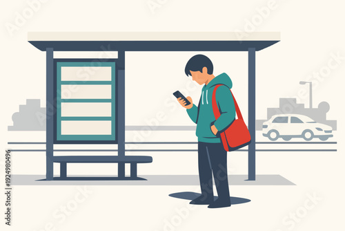Young man using smartphone while waiting at city bus stop for public transit