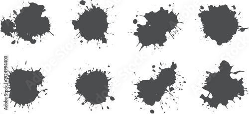 Eight dark grey ink splatters on white background paint splatter