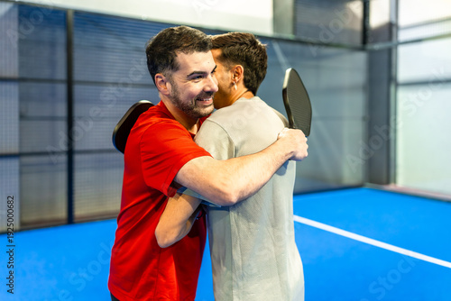 Bild auf Leinwand Pickleball players hugging on court celebrating sportsmanship