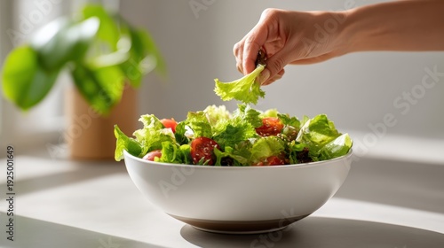 Natural light photo, making salad bowl in a cozy kitchen, top view or side view, candid composition, human touch included (hand tossing greens, sprinkling seeds, or drizzling dressing), clean