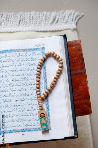 Wallpaper Mural The holy Quran and prayer beads or tasbih on a rehal, capturing a serene atmosphere of devotion Torontodigital.ca