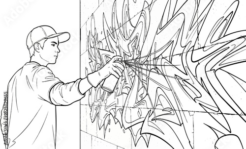 Young artist in cap sprays graffiti art on brick wall with spray can