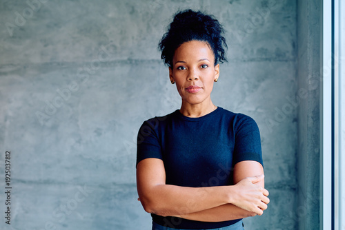 Quadro su tela Professional businesswoman standing with a determined expression, embodying stre