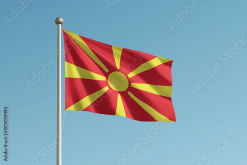 North Macedonia national flag waving on pole against clear blue sky background.