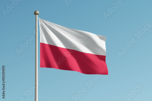 Poland national flag waving on pole against clear blue sky background.