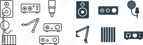 Collection of audio gear including speakers, a microphone, an audio interface, and sound panels arranged neatly, showcasing essential tools for music production and recording.