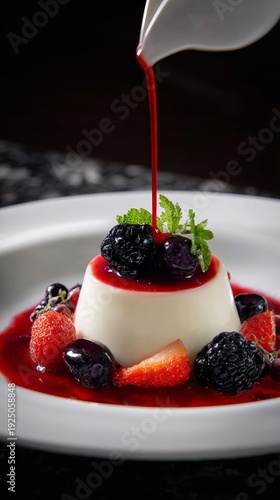 Creamy panna cotta with mixed berry sauce and fresh fruit