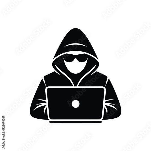Silhouette of hooded figure using laptop representing hacker or anonymous online activity