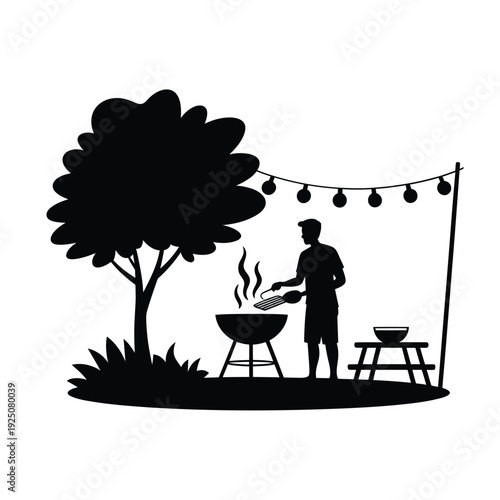 Silhouette of a man grilling outdoors under string lights tree and picnic table visible