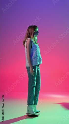 Full body woman in cable knit vest and jeans rotating 360 on bright gradient neon backdrop. Concept of contemporary fashion branding, seasonal collection showcase and creative personal style content.