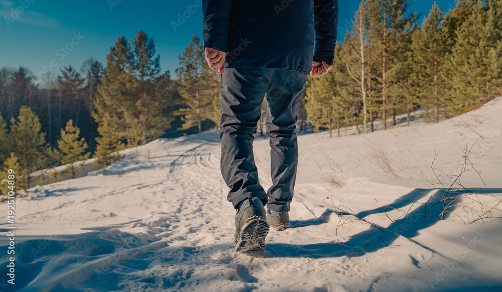 Fototapeta premium man foot steps in winter
