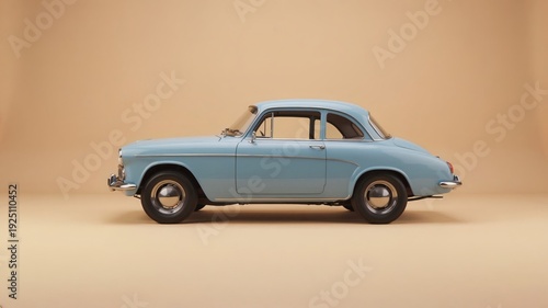 A Light Blue Vintage Automobile Captures Timeless Elegance on a Warm Beige Background