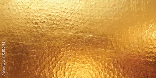 Golden hammered glass texture with warm luminous reflections abstract metallic translucent background