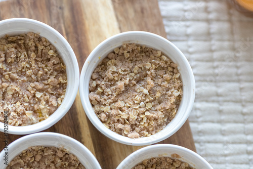 Healthy oatmeal breakfast bowls on a wooden board