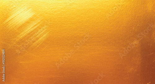 Abstract golden brushed metal texture background with smooth metallic gradient and reflective sheen