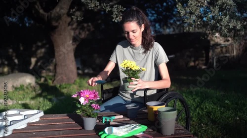 Disabled woman in wheelchair enjoying gardening hobby