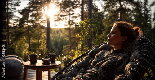 Wallpaper Mural Woman relaxing in chair on forest terrace of countryside house in warm morning sunlight. Outdoor slow living and wellness lifestyle concept for retreat marketing and real estate. Torontodigital.ca