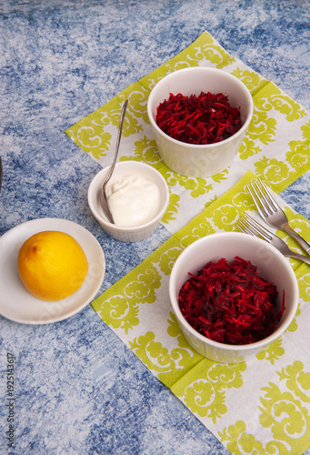 Salad of Fresh Raw Beetroot with Grated Raw Carrot, Apple and Orange on Kitchen Table. Selective Focus.