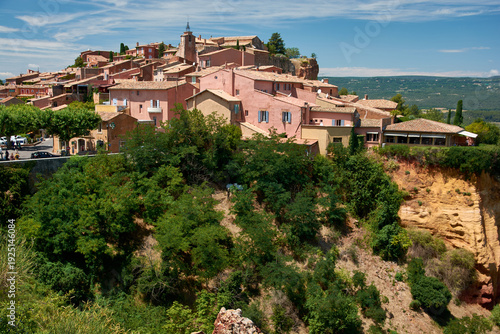 Terracotta colored houses of Roussillon village situated on an ochre ridge, Vaucluse, Provence-Alpes-Cote d'Azur, France.