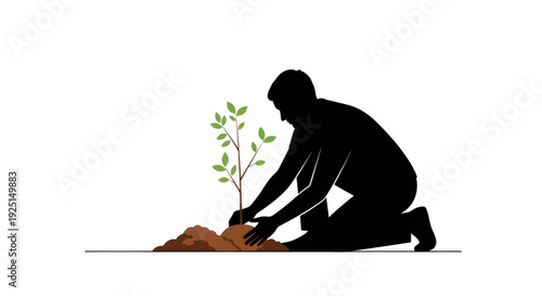 Silhouette of a person kneeling to plant a young green sapling in the soil for reforestation