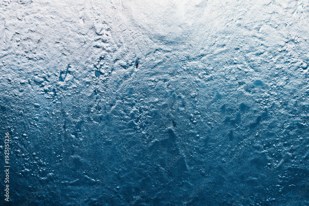 Obraz premium Frozen ice texture creating a cool, abstract winter background. Rough, granular surface showing cold temperatures and frozen liquid