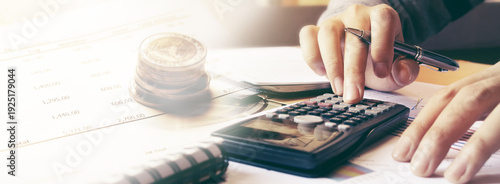 Man using calculator and calculating budgeting and tax calculation monthly expenses.