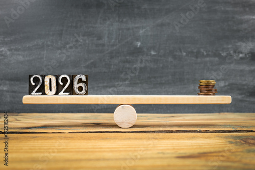 2026 Balance Concept With Coins On Wooden Seesaw Financial Planning