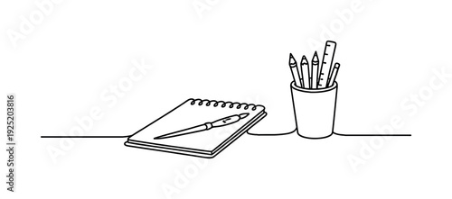 "Creative Workspace". Minimalistic one-line drawing simple desk scene with notebook, paintbrush, and cup