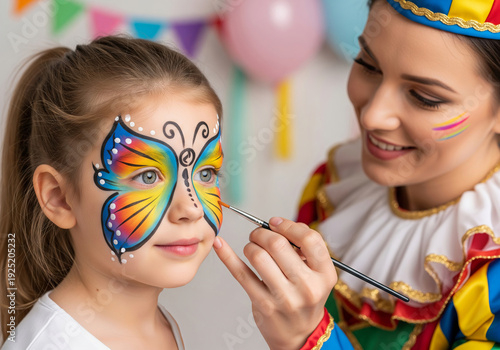Woman face painter applying butterfly design on a kid girl face. Fun activity for birthday party, festival, or carnival for child, kids entertainer