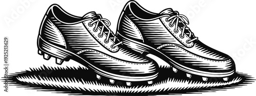 Classic vintage football cleats on grass, black and white engraved illustration
