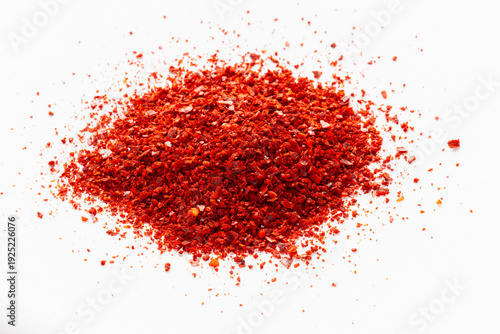 A heap of gochugaru, Korean chili pepper seedless flakes, on a white background. An important ingredient in Korean cuisine.