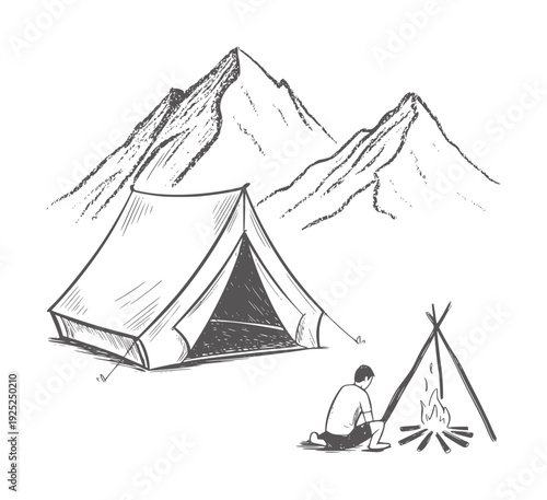 Black and white of a person sitting by a campfire next to a tent with mountains in the
