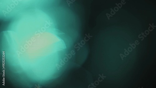 Light leak and bokeh overlay with teal and green hues, creating a dreamy, ethereal mood. Perfect for adding artistic effects to your videos.
