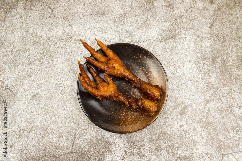 Fototapeta premium The marinated chicken feet in the round dish