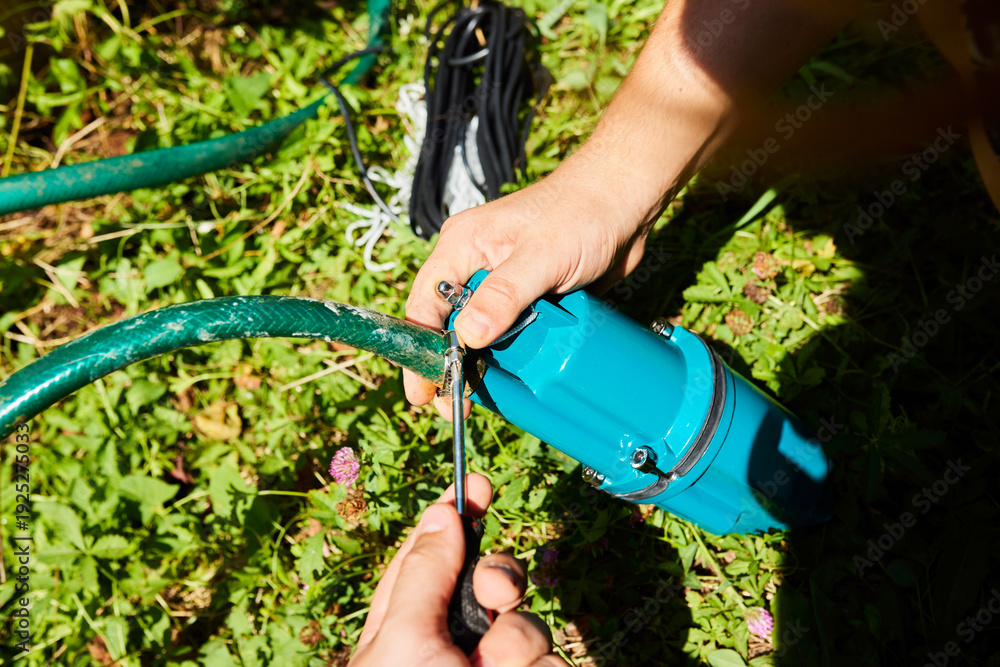 Fototapeta premium Connection of a pump for pumping water from a well