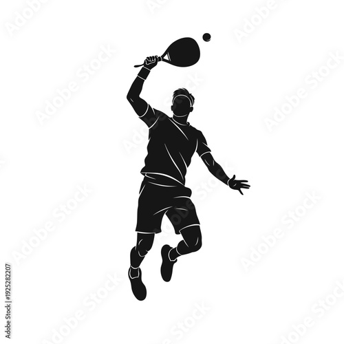 Silhouette of a male tennis player jumping to hit the ball during a match