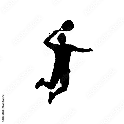 Silhouette of a tennis player jumping and hitting the ball during a match