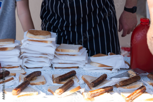 BBQ sausages and bread lined up ready to eat.