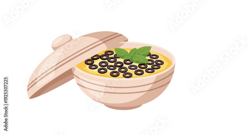 Ceramic bowl filled with delicious yellow hummus or dip topped with many black olives and fresh green basil leaves.