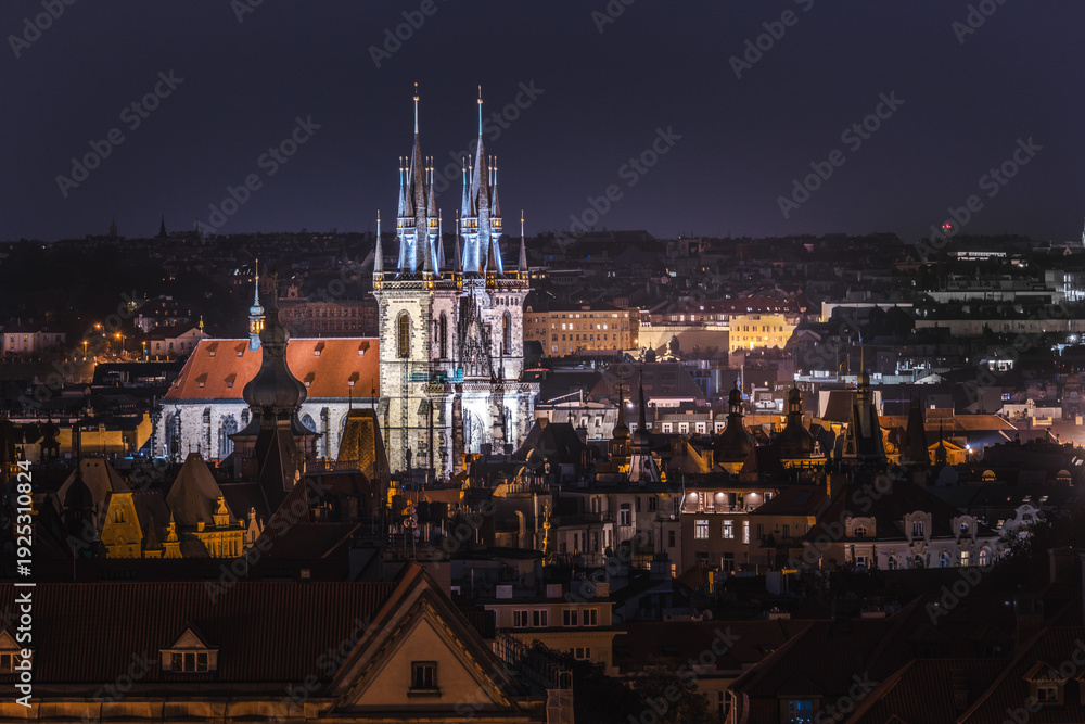 Fototapeta premium Night cityscape of Prague with illuminated Church of Our Lady before Tyn and historic rooftops in Old Town Czech Republic