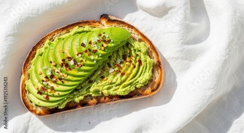 Delicious slice of toasted bread topped with mashed avocado and spices