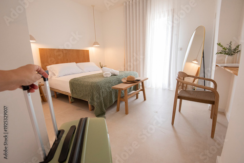 Canvastavla Hand pulling suitcase entering modern hotel room for vacation