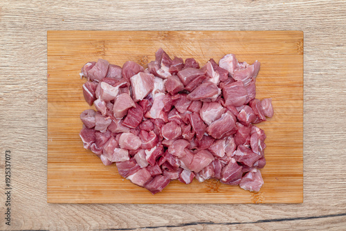Bild auf Leinwand Raw pork shoulder and neck diced on cutting board