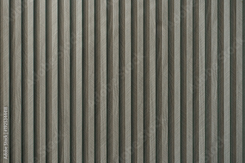 Macro texture of grey fluted wall panels with a wood grain finish, ideal for modern architectural backgrounds.